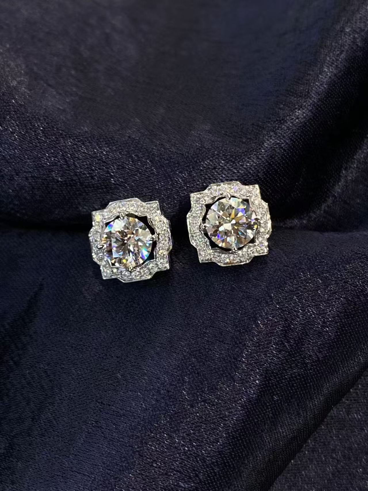 Round brilliant halo lab diamond stud earrings on dark velvet background - product shot