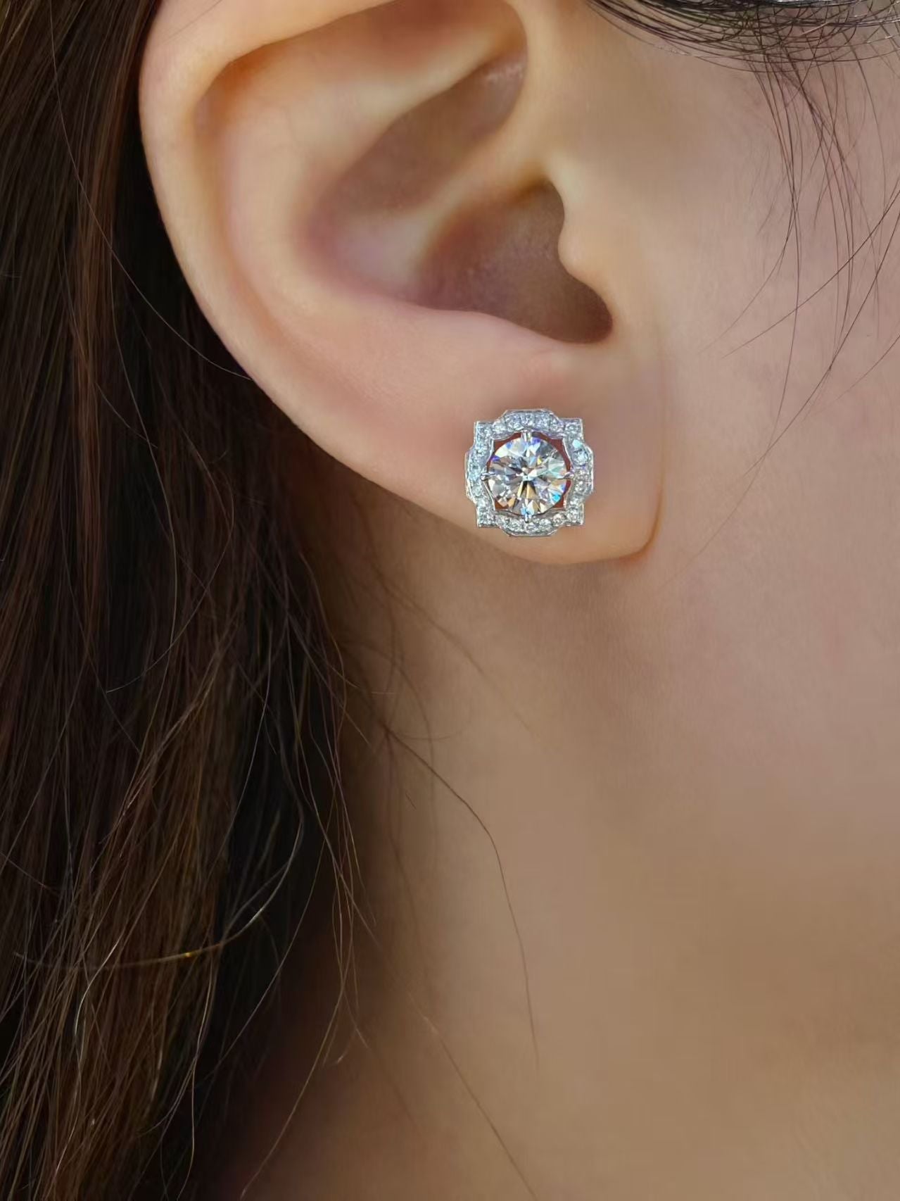 Round brilliant halo lab diamond stud earring worn on ear - lifestyle shot